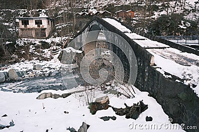 Turkey, Artvin, cifte kopru, Stone made bridge at winter, snow covers the bridge at winter. Stock Photo
