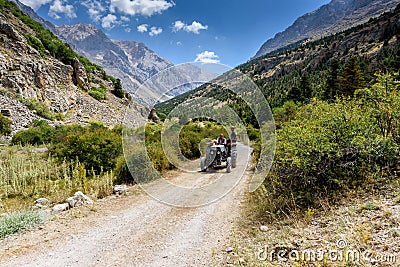 Turkey, Chamard - August 3, 2019: an elderly Turkish man drives an old tractor with a passenger on a road with a Editorial Stock Photo