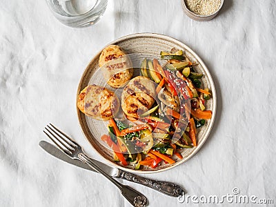 Turkey cutlets grill, vegetables steer fry and white sesame on plate on the table. Top view Stock Photo