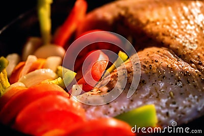 Turkey garnished with vegetables in during cooking Stock Photo