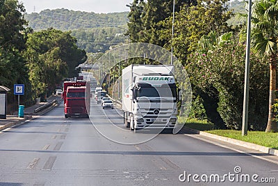 Heavy trucks drive on a highway in Turkey. Trucks rush along Turkish roads. Travel to Turkey. Editorial Stock Photo