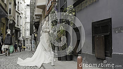 Turkey, Istanbul - July 27, 2022: Young fashionable luxury girl bride in elegant long wedding white dress in the narrow Editorial Stock Photo