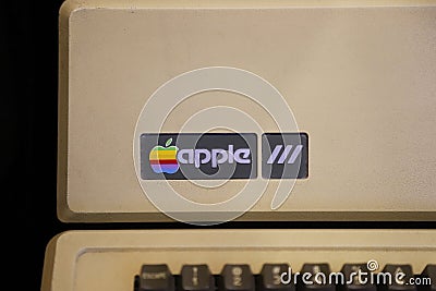 Old rainbow Apple logo on old Macintosh computer. Editorial Stock Photo