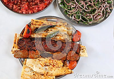 Turkish Adana and Shish Kebabs with Onion and Tomatoes Salads Stock Photo