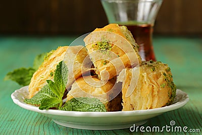 Turkish arabic dessert - baklava with honey and pistachios Stock Photo