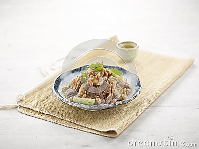 Turkish beef liver Slices in a dish with isolated on wooden mat side view on grey background Stock Photo