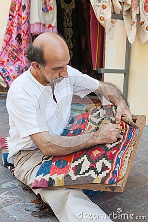 Turkish carpet master repearing old traditional turkish carpet Editorial Stock Photo
