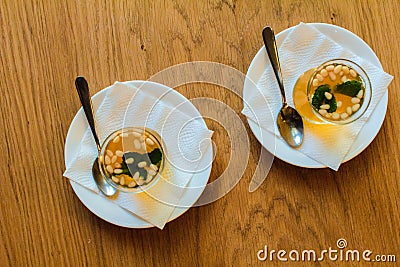 Turkish citrus tea in small cups, with the addition of pine nuts and mint leaves. Stock Photo