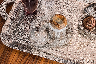 Turkish coffee served with sherbet and cookies in traditional copper serving set Stock Photo