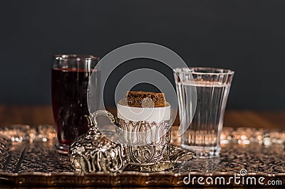 Turkish coffee served with water and sherbet on traditional copper serving set Stock Photo