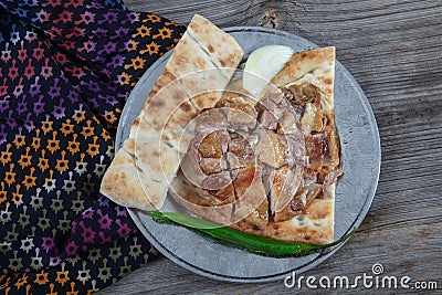 Turkish cuisine lamb ribs on pita bread. Tandoori style lamb chops and spiked pita served with green peppers and onions Stock Photo