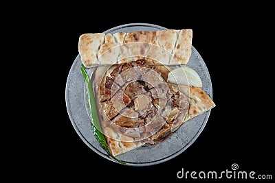 Turkish cuisine lamb ribs on pita bread. Tandoori style lamb chops and spiked pita served with green peppers and onions Stock Photo