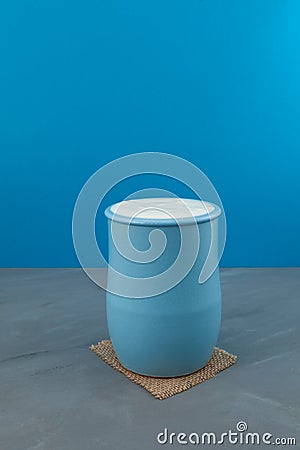 Turkish drink Ayran or kefir in a blue ceramic jug. Fermented milk drink. Diet drink for weight loss. Buttermilk from yogurt. Stock Photo