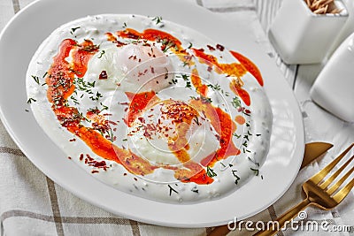 Turkish eggs with greek yogurt and aleppo pepper Stock Photo