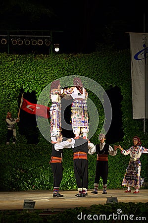 Turkish female dancers upright on men shoulders Editorial Stock Photo