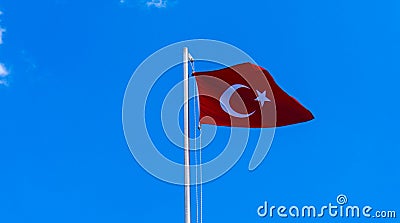 Turkish flag waving in blue sky Stock Photo