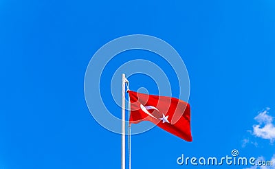 Turkish flag waving in blue sky Stock Photo