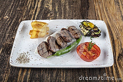 Turkish Food Meatball Kofte. Kofta with Tomatoes and Onion in Plate Portion. Grilled Kofte. Spicy meatballs Kebab or Kebap healthy Stock Photo