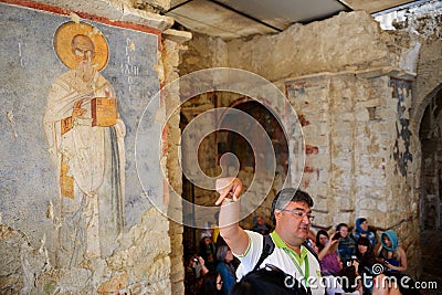 Turkish guide tells for tourists the story about church of St. Nicholas Editorial Stock Photo
