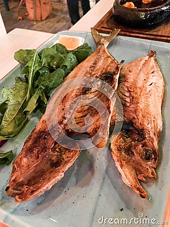 Turkish Leer Fish Akya Baligi / Leerfish or Kuzu Baligi served at Restaurant with Arugula Rocket leaves. Stock Photo