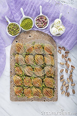 Turkish Midye Baklava Mussel Shape Baklava with green pistachio Powder and Butter Cream. Famous Turkish Gaziantep baklava Stock Photo