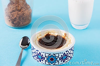 Turkish milky dessert Sutlac with cinnamon and milk Stock Photo