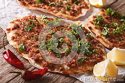 Turkish pizza with meat - lahmacun macro on the table. Horizontal Stock Photo