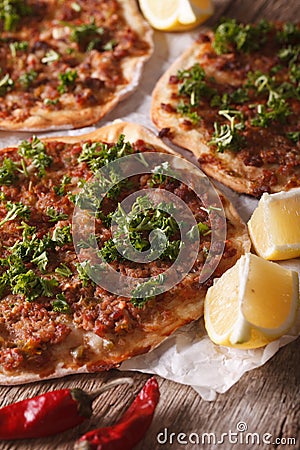 Turkish pizza with meat - lahmacun macro on the table. vertical Stock Photo