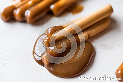 Turkish Tahin Pekmez / Tahini and Molasses with Salty Pretzel Stick Crackers. Stock Photo