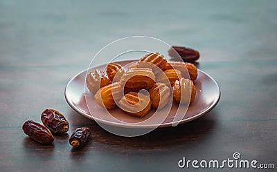 Turkish Tulumba sweets and dates Stock Photo