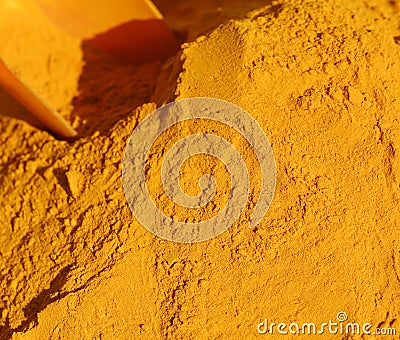 Turmeric Curry powder background and a red bailer Stock Photo