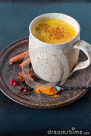 Turmeric golden milk latte with cinnamon sticks Stock Photo