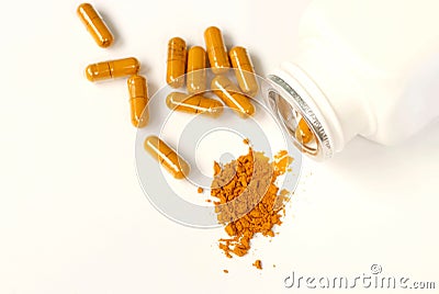 Turmeric powder and capsules on white background with copy space, herbal medicine curcumin or curcuma for good health Stock Photo