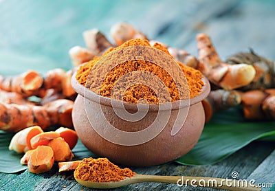 Turmeric powder in ceramic bowl Stock Photo