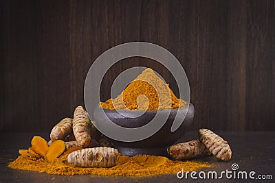 Turmeric powder and roots Stock Photo