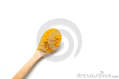 A turmeric powder in a wooden spoon. Stock Photo