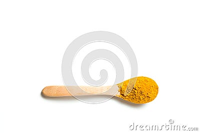 A turmeric powder in a wooden spoon. Stock Photo