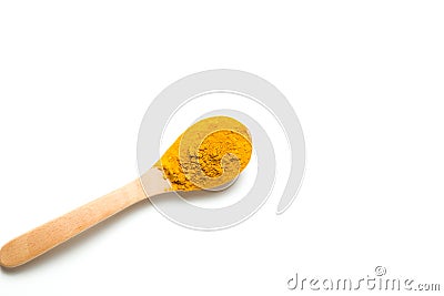 A turmeric powder in a wooden spoon. Stock Photo