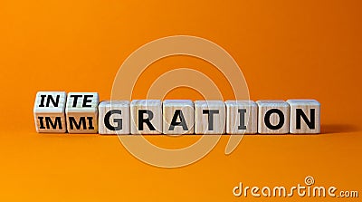 Turned a cube and changed the word `immigration` to `integration`. Beautiful orange background. Business concept. Copy space Stock Photo