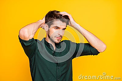 Turned photo of worried troubled man having problem of hair loss looking down disappointed with effect of newly bought Stock Photo