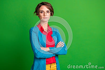 Turned photo of young attractive girl confident serious crossed arms over vibrant green color background Stock Photo