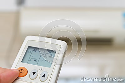 turning on air conditioner via a remote control Stock Photo