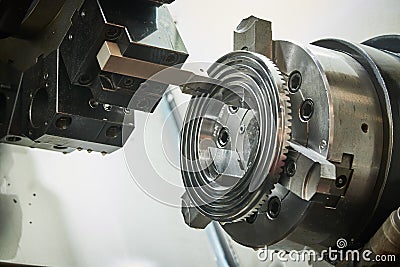 turning operation on cnc machine in metalworking industry. Cutting tool makes spiral groove on metal detail face Stock Photo