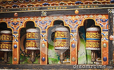 Turning prayer wheels mantra in Bhutan with traditional writing mantra which sounds as Om mani padme hum, literally means Oh, jewe Stock Photo