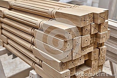 Turning wooden stair balusters. Wood stair balusters stacked in workshop Stock Photo