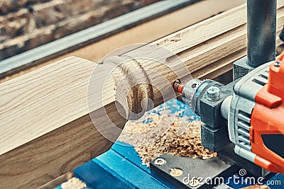 Turning wooden stair balusters. Wood stair balusters manufacturing process on a turning lathe with milling cutter Stock Photo