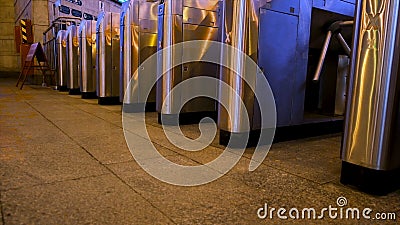 The turnstile of a subway station with people passing through, public transportt. Concept. Modern turnstiles for the Stock Photo