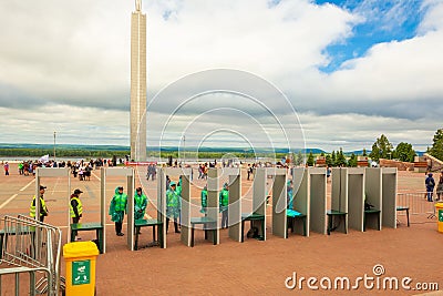 Turnstiles with arched frame metal detectors and security officers Editorial Stock Photo