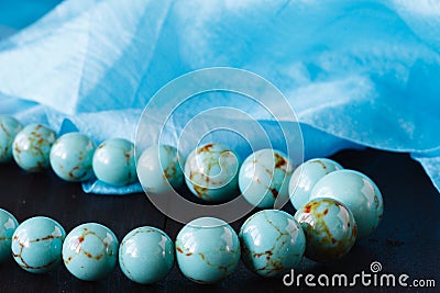 Turquoise bead on a wooden Stock Photo