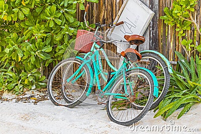 Turquoise bikes bicycles at caribbean coast and beach Tulum Mexico Editorial Stock Photo